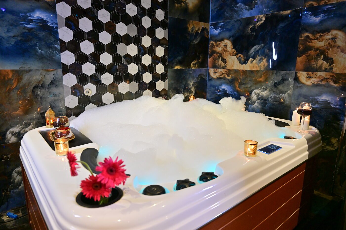 Luxury bubble jacuzzi with candles and wine glass at 111 International Spa Gachibowli