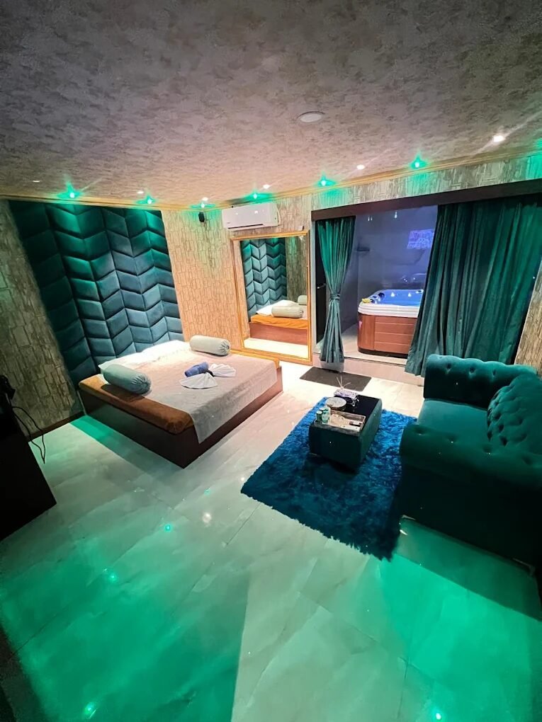 Emerald-lit luxury suite with private in-room jacuzzi at 111 International Spa, Gachibowli